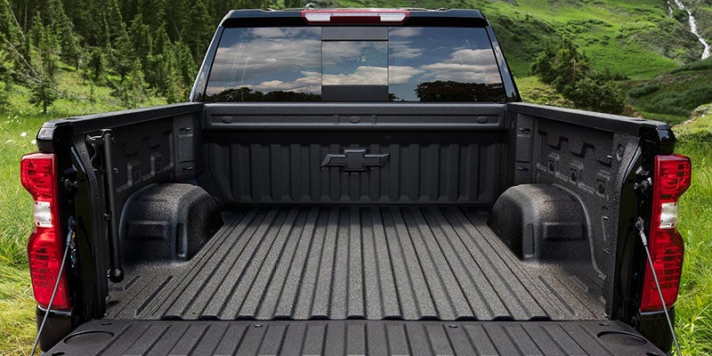 Black pickup truck bed with Chevrolet bowtie emblem