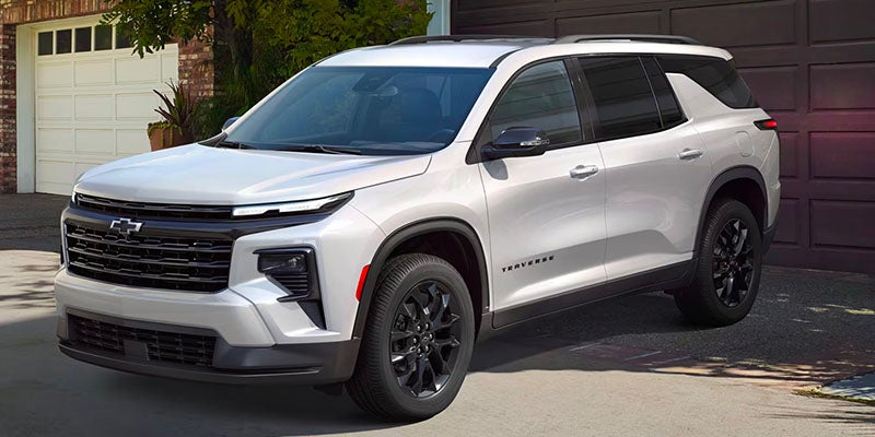 White SUV parked front of Garage