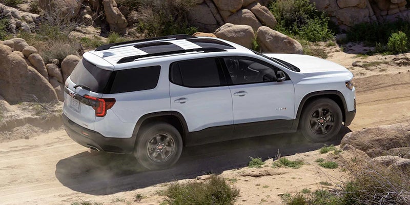 White Acadia Off roading top and right side view