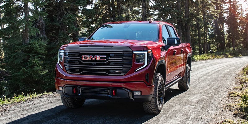 A GMC Sierra running on road between Jungle