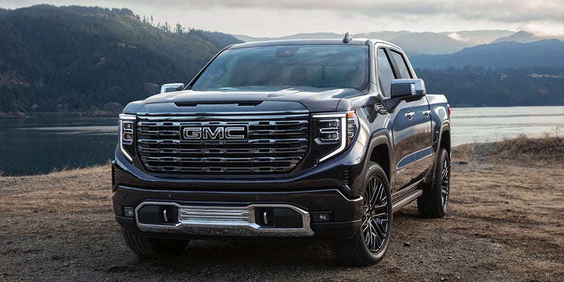 A black truck stands front of river front view